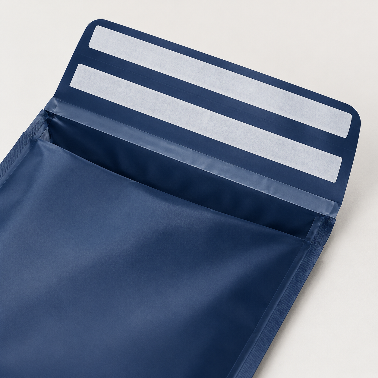 Illustrative mailer flap showing separate protected adhesive zones and an opening feature clear of the return seal